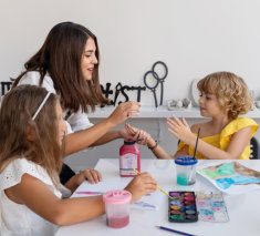 Teacher At Art School Playing Children in Art Class with Acrylic Paint