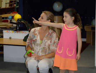 Woman and girl pointing at unseen object