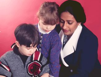 A woman and two children sitting at a table